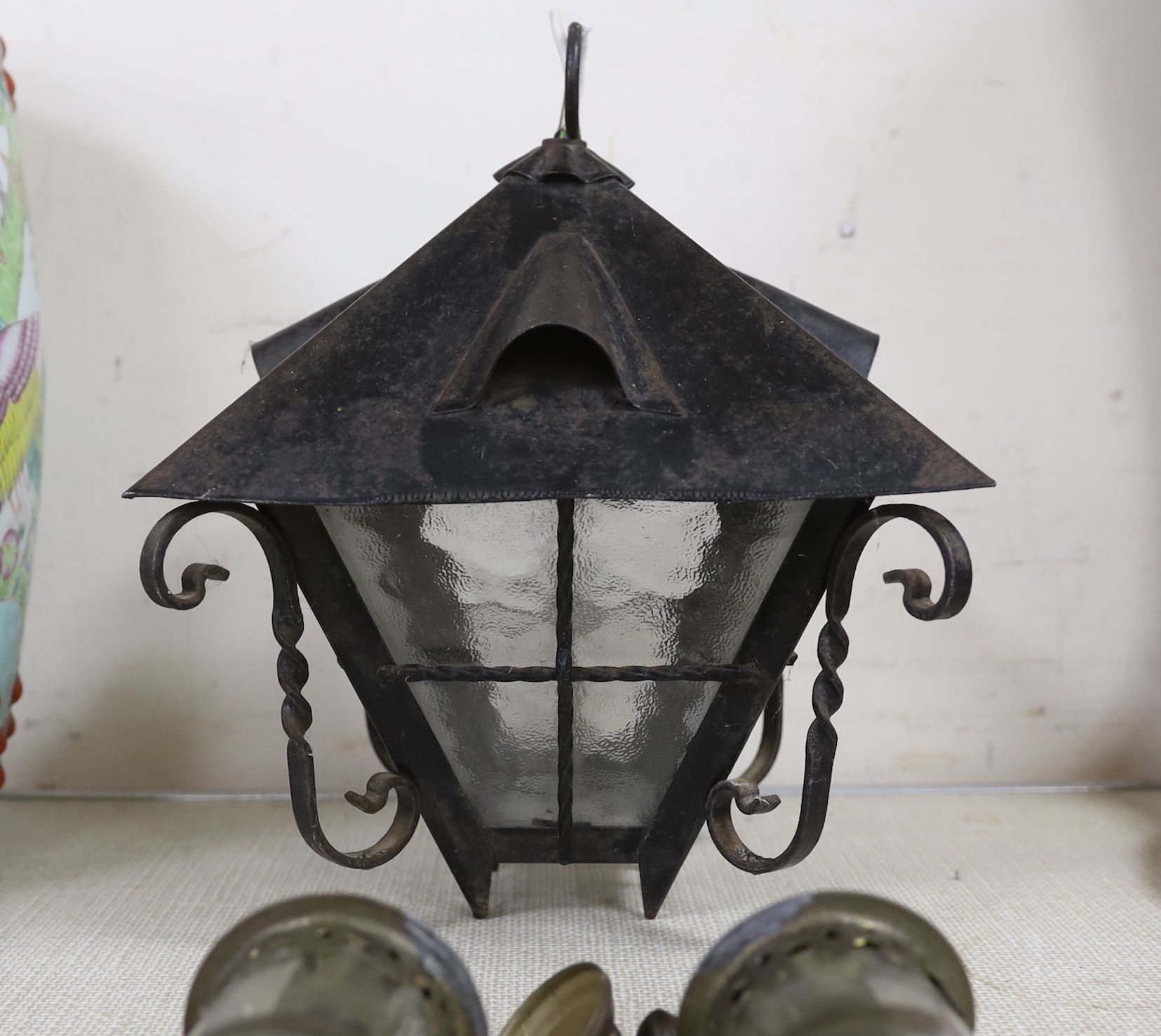 A pair of GWR railway lamps and a wrought iron hanging lantern, largest each 35cm high